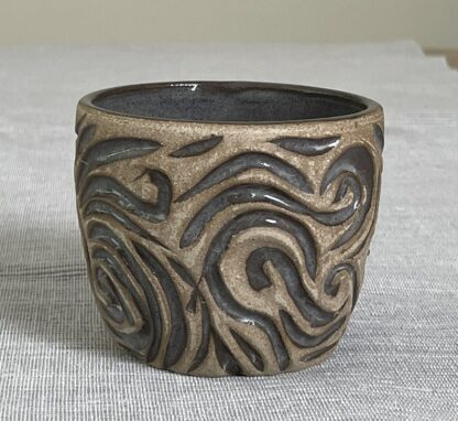 Toffee tumbler with swirly carvings