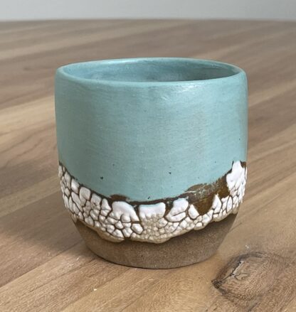 Light teal tumbler with a cloud-like belt