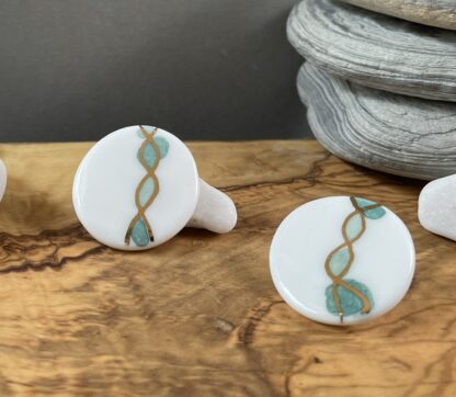 Round earrings with gold and green helix