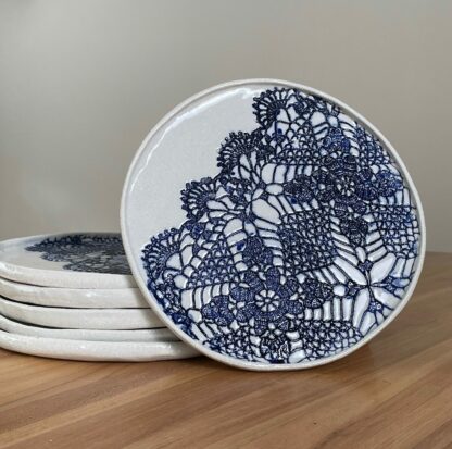 Porcelain dinner plate decorated with crocheted blue embossing