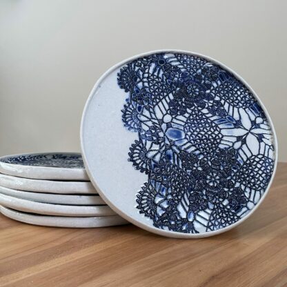 Porcelain dinner plate decorated with crocheted blue embossing