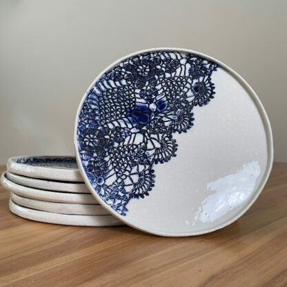 Porcelain dinner plate decorated with crocheted blue embossing