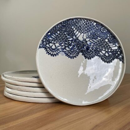 Porcelain dinner plate decorated with crocheted blue embossing