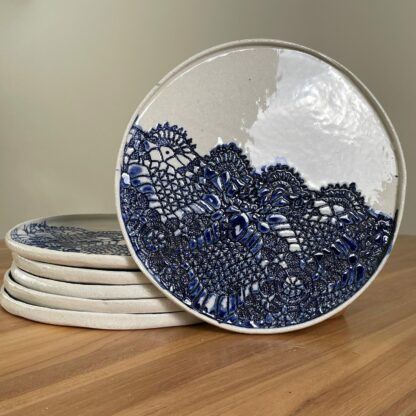 Porcelain dinner plate decorated with crocheted blue embossing