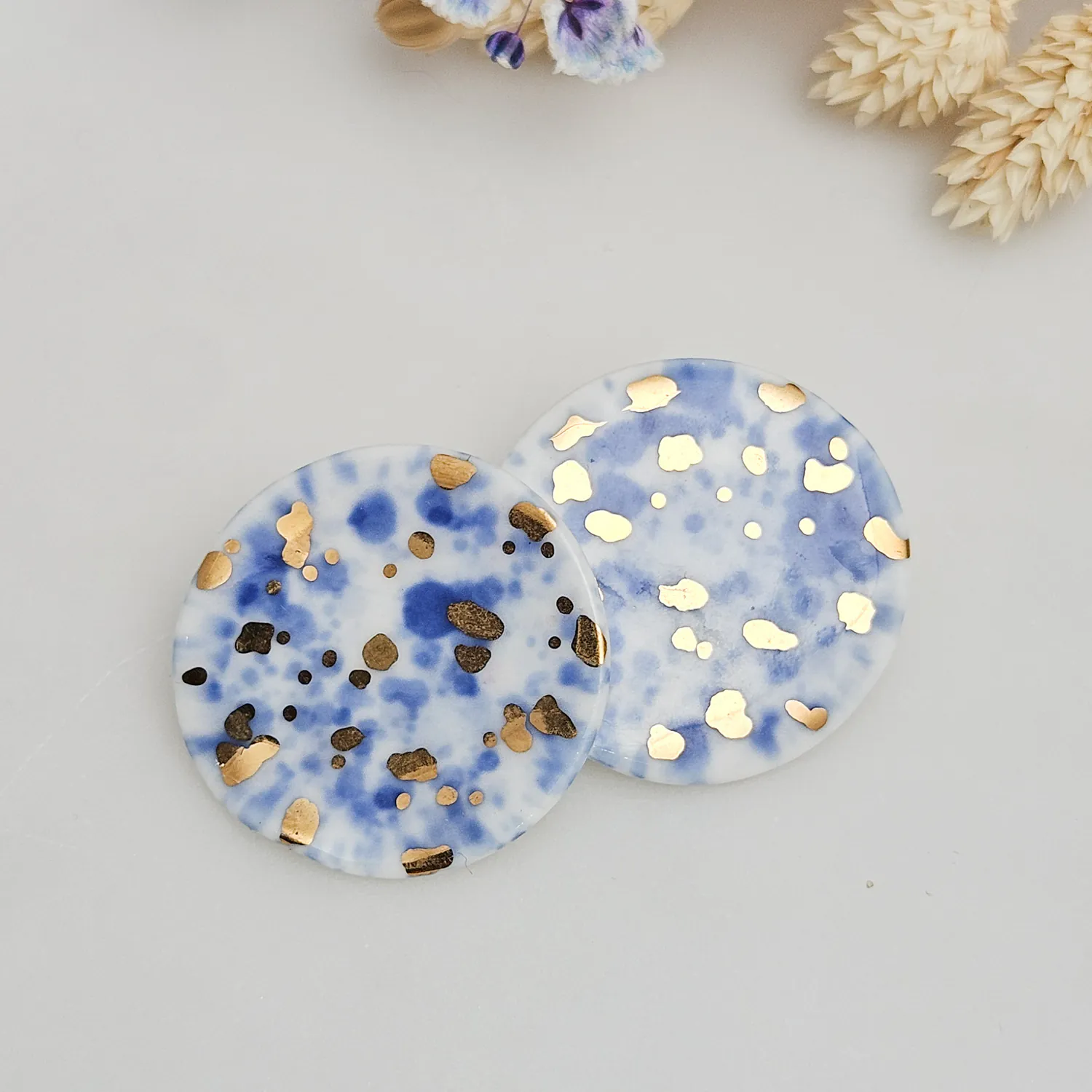 Round porcelain stick-earrings - blue splash speckles with gold