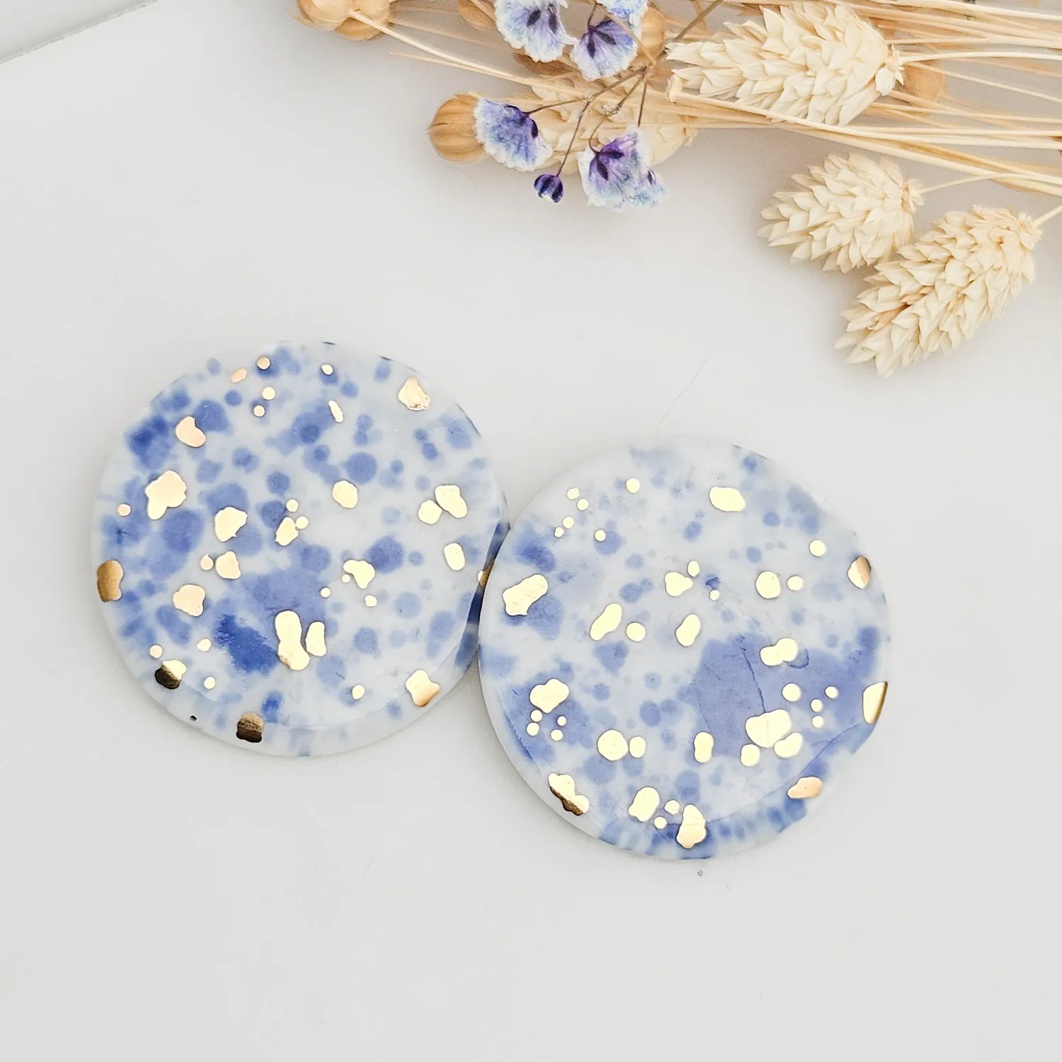 Round porcelain stick-earrings - blue splash speckles with gold