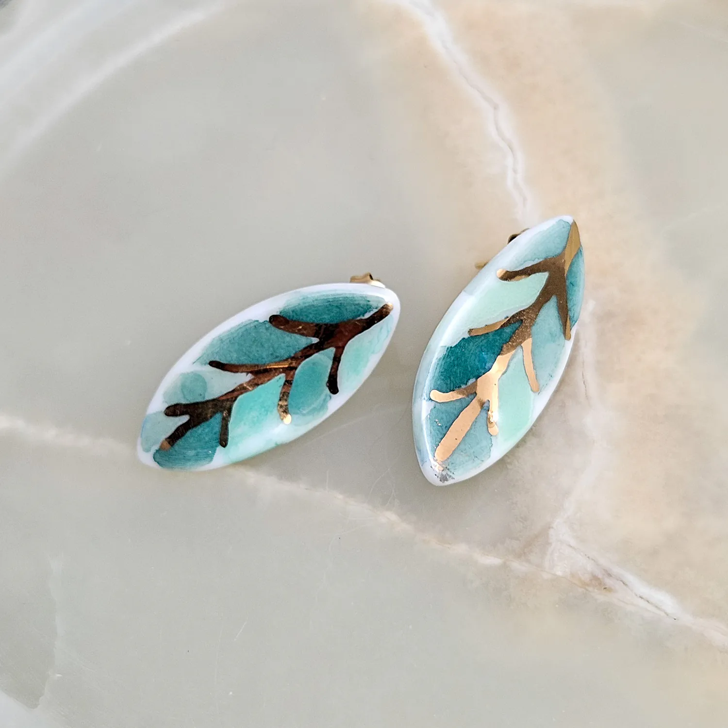 Porcelain stick-earrings - green leaf with gold