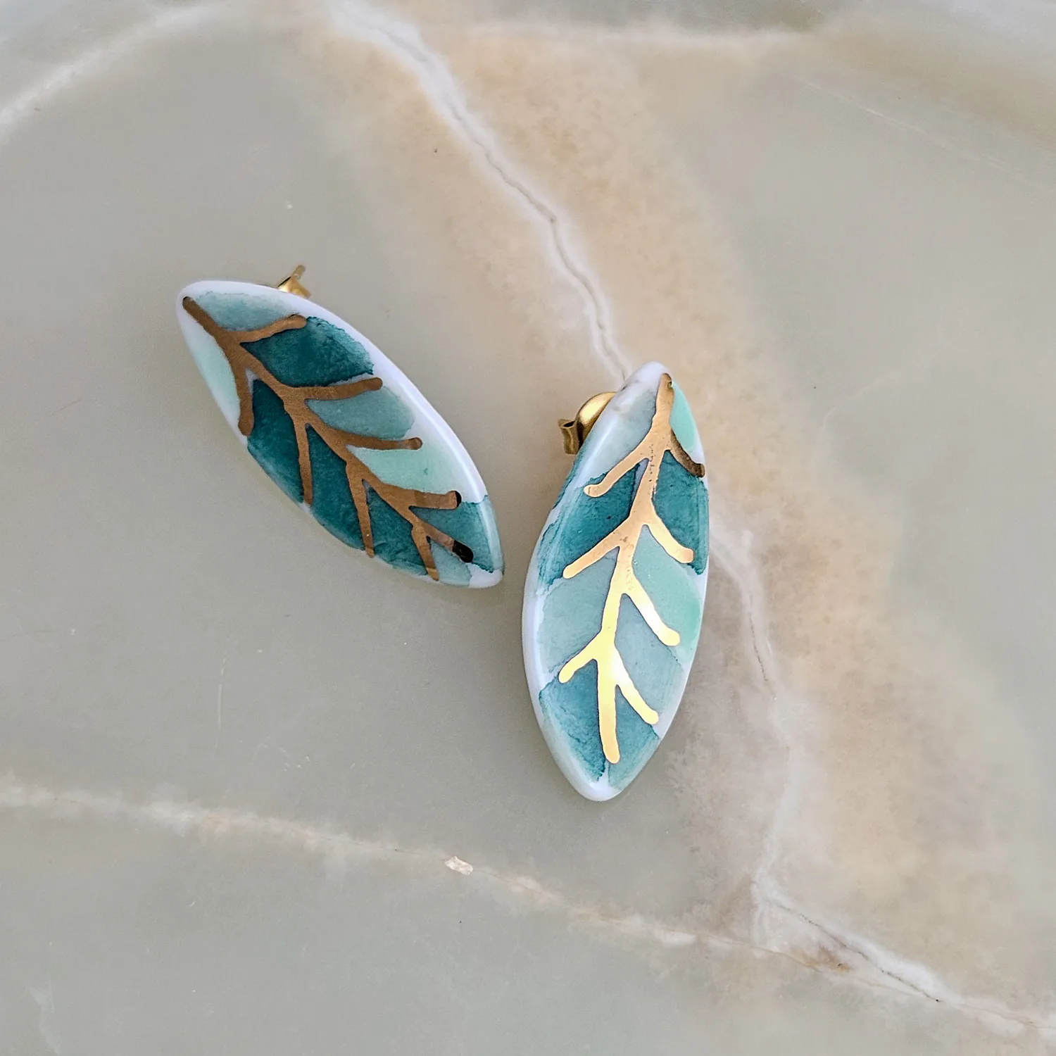 Porcelain stick-earrings - green leaf with gold