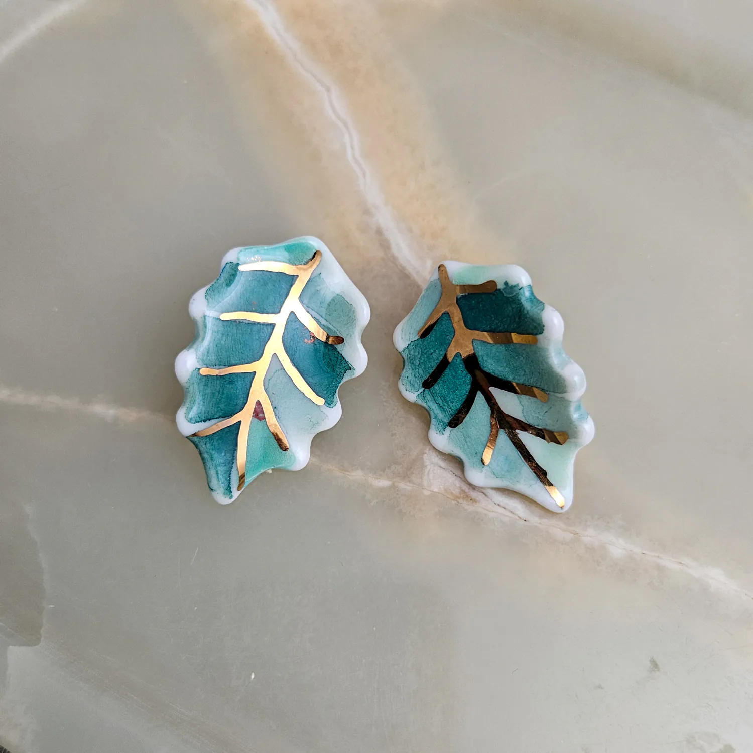 Porcelain stick-earrings - green leaf with gold