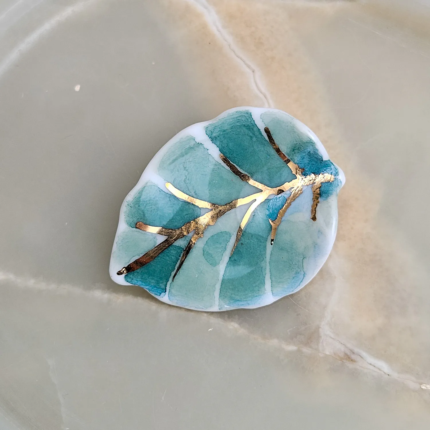 Porcelain brooch - green leaf with gold
