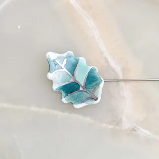 Fine ceramic fine ceramic porcelain brooch - green leaf with silver accents (white gold)