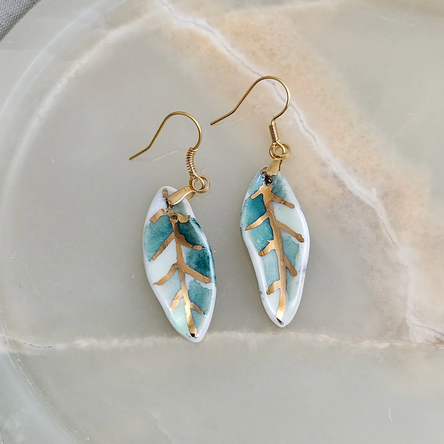 Hanging porcelain earrings - green leaf with gold