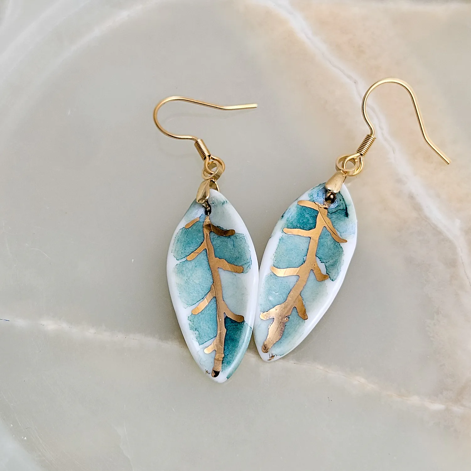 Hanging porcelain earrings - green leaf with gold