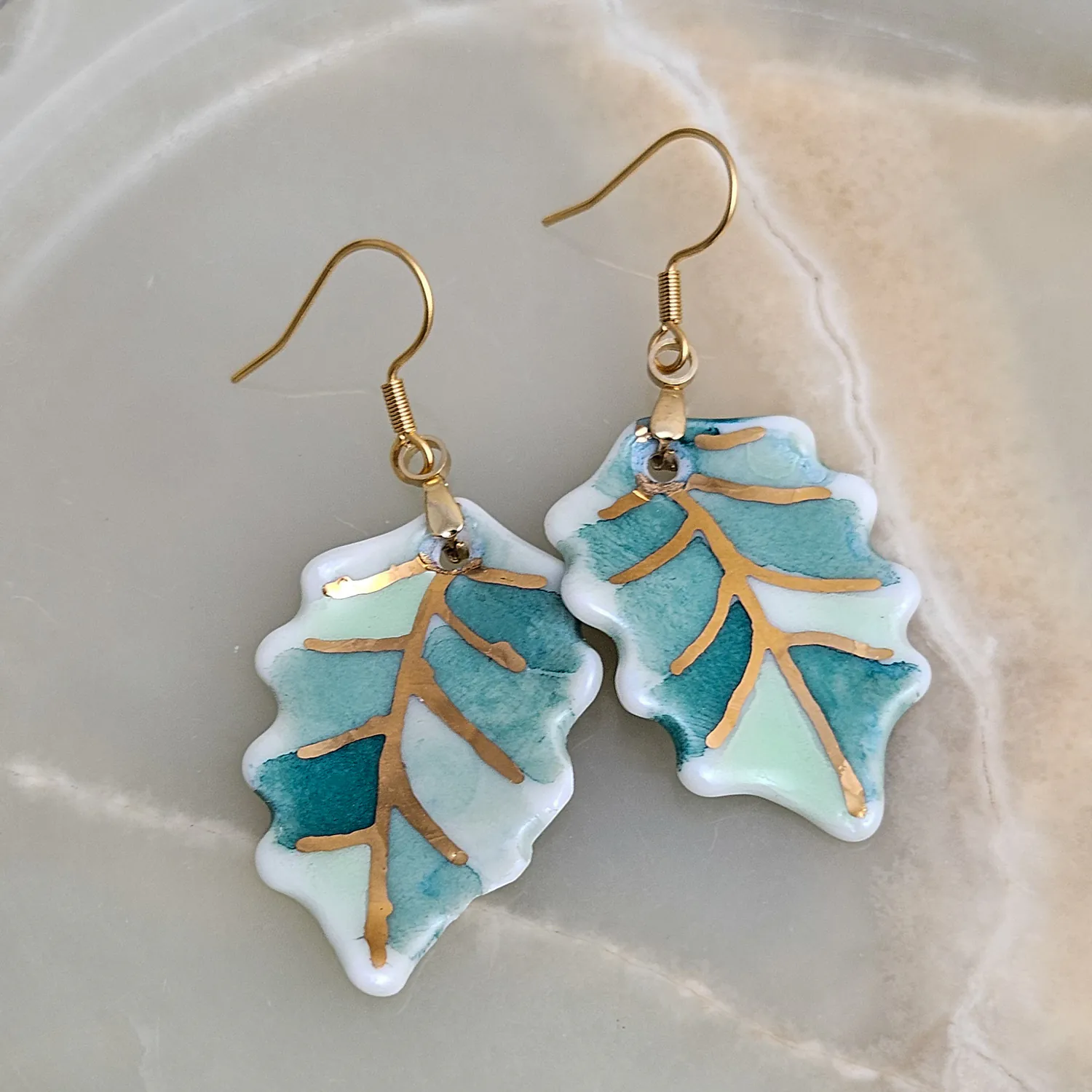 Hanging porcelain earrings - green leaf with gold
