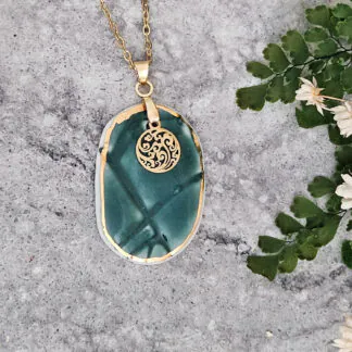 Emerald green fine ceramic porcelain designer necklace - embossed plant with 22k gold plating and round pendant with wavy patten