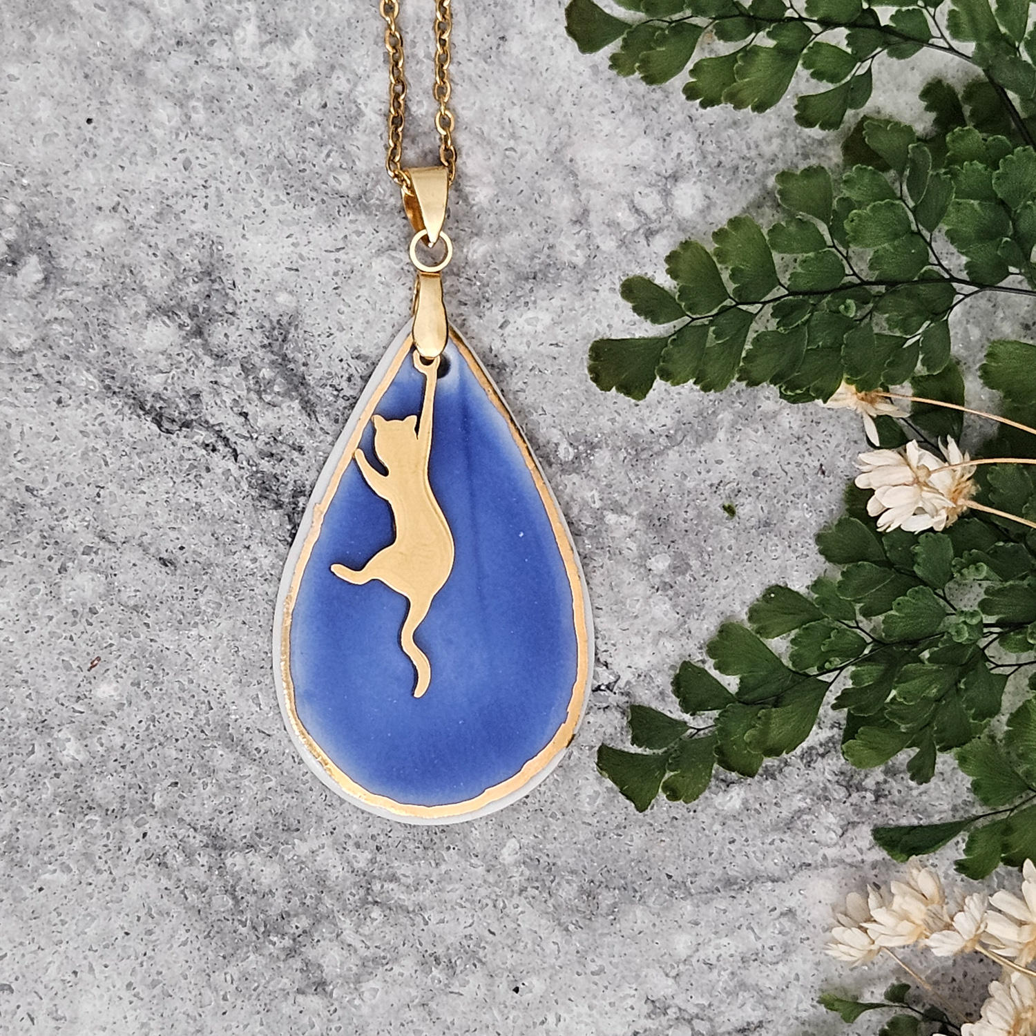 Cobalt blue fine ceramic porcelain designer necklace - embossed plant with 22k gold plating and cat pendant