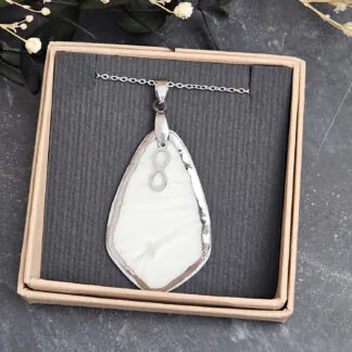Light blue fine ceramic porcelain designer necklace - embossed plant with silver accents (white gold) and infinity symbol pendant