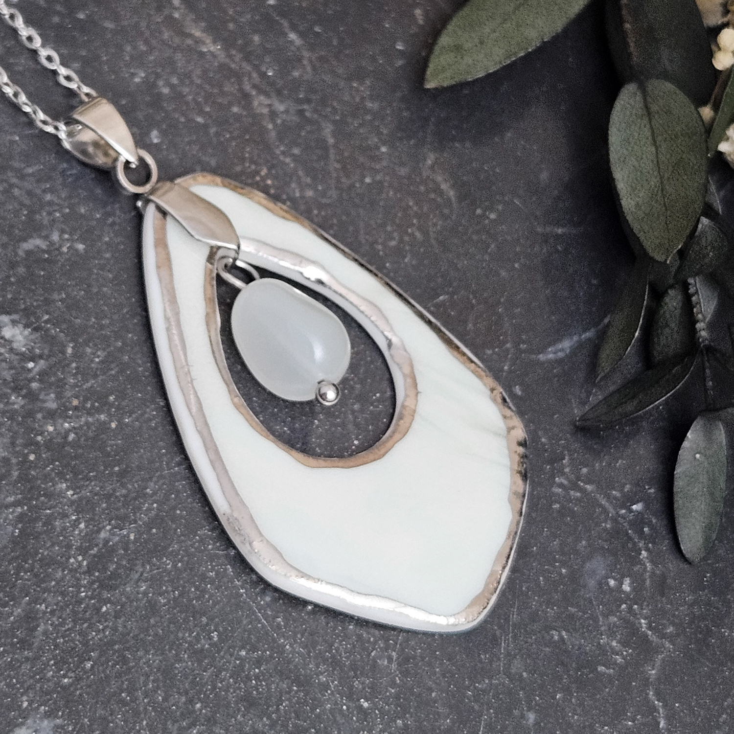 Light blue fine ceramic porcelain designer necklace - embossed plant with silver accents (white gold) and moonstone - obrazek 2