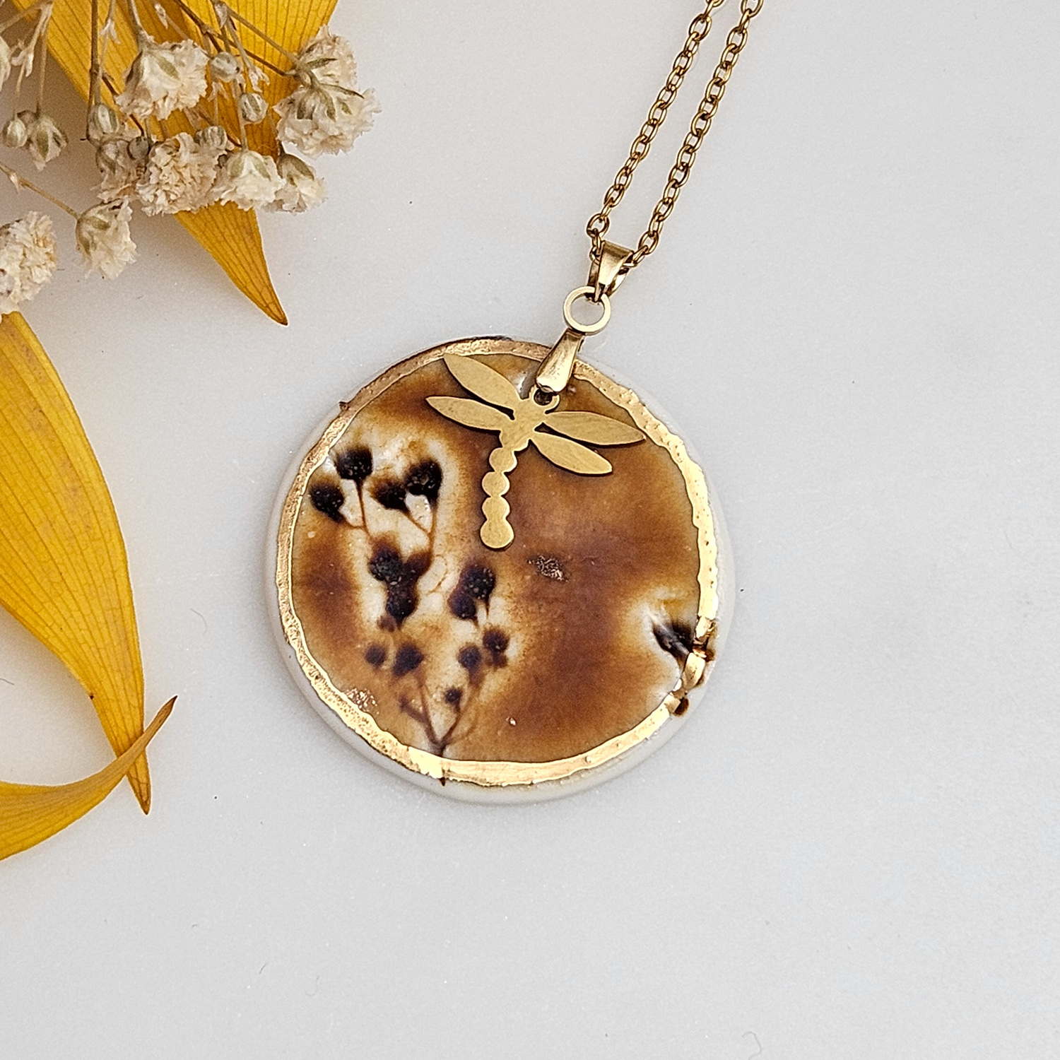 Amber fine ceramic porcelain designer necklace - embossed plant with 22k gold plating and dragonfly pendant
