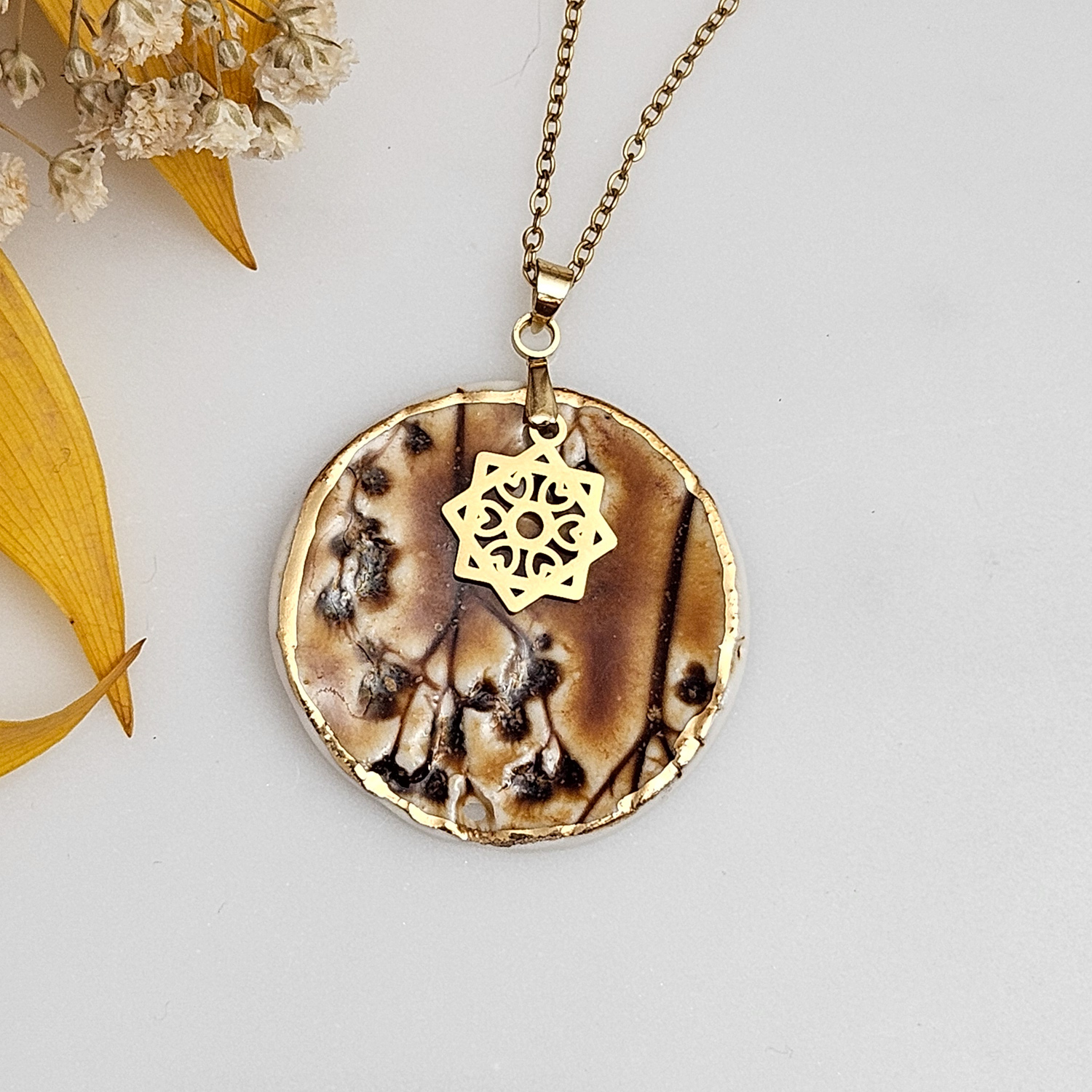 Amber fine ceramic porcelain designer necklace - embossed plant with 22k gold plating and star pendant