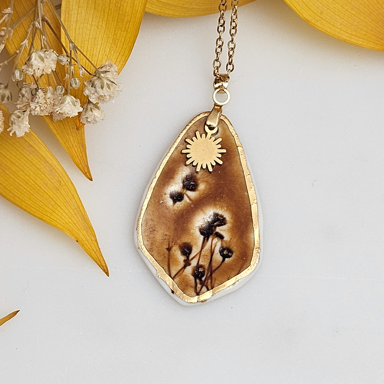 Amber fine ceramic porcelain designer necklace - embossed plant with 22k gold plating and sun pendant