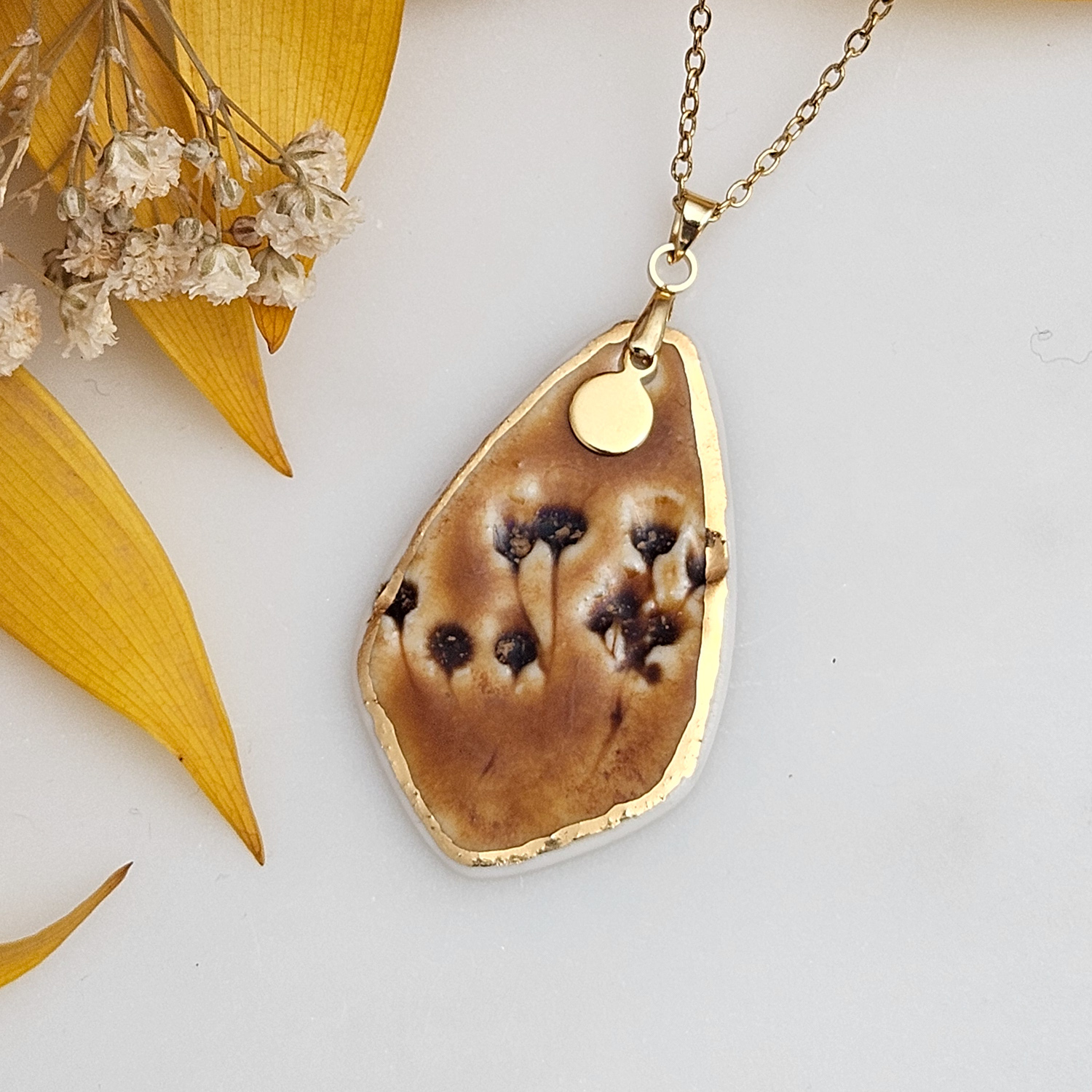 Amber fine ceramic porcelain designer necklace - embossed plant with 22k gold plating and round pendant