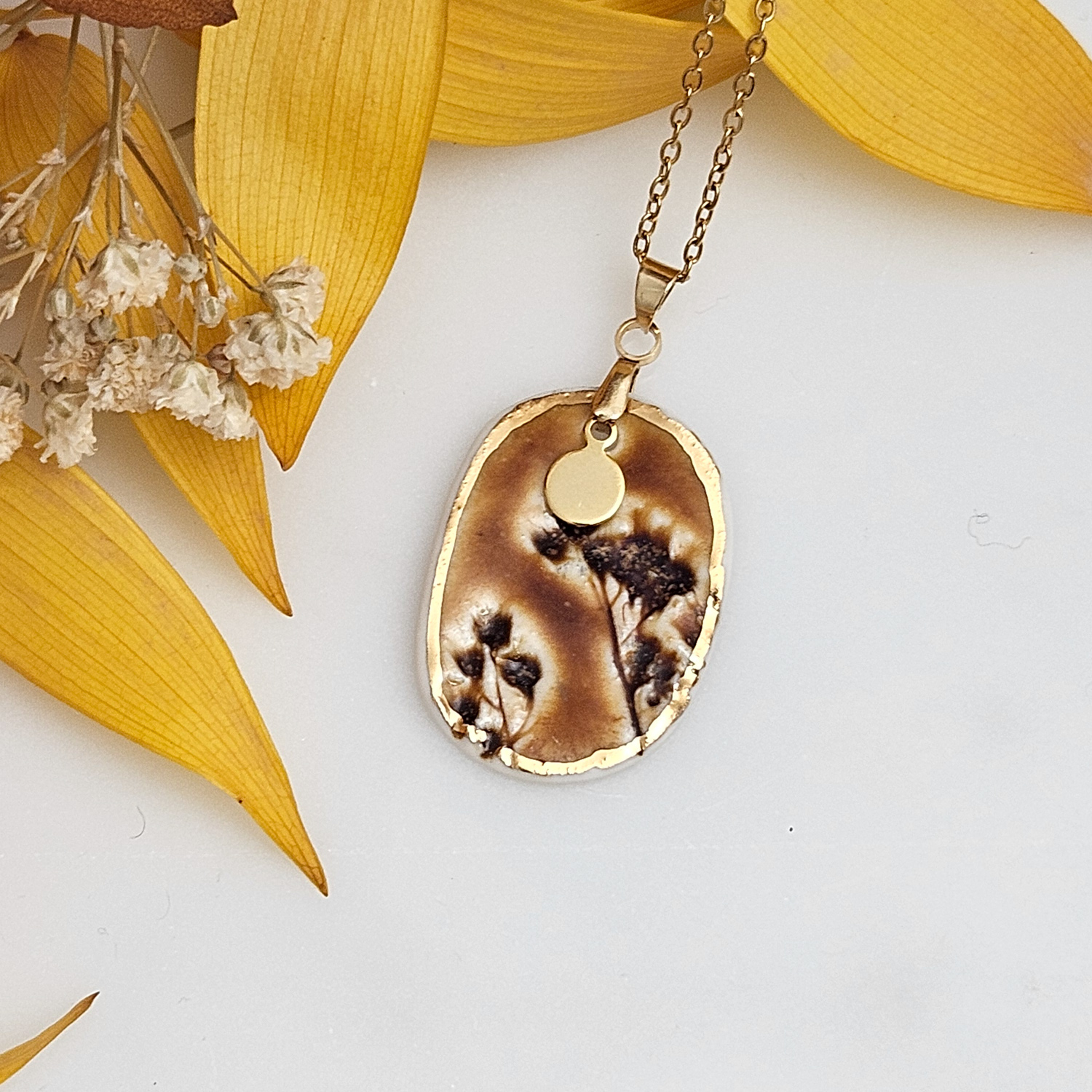 Amber fine ceramic porcelain designer necklace - embossed plant with 22k gold plating and round pendant