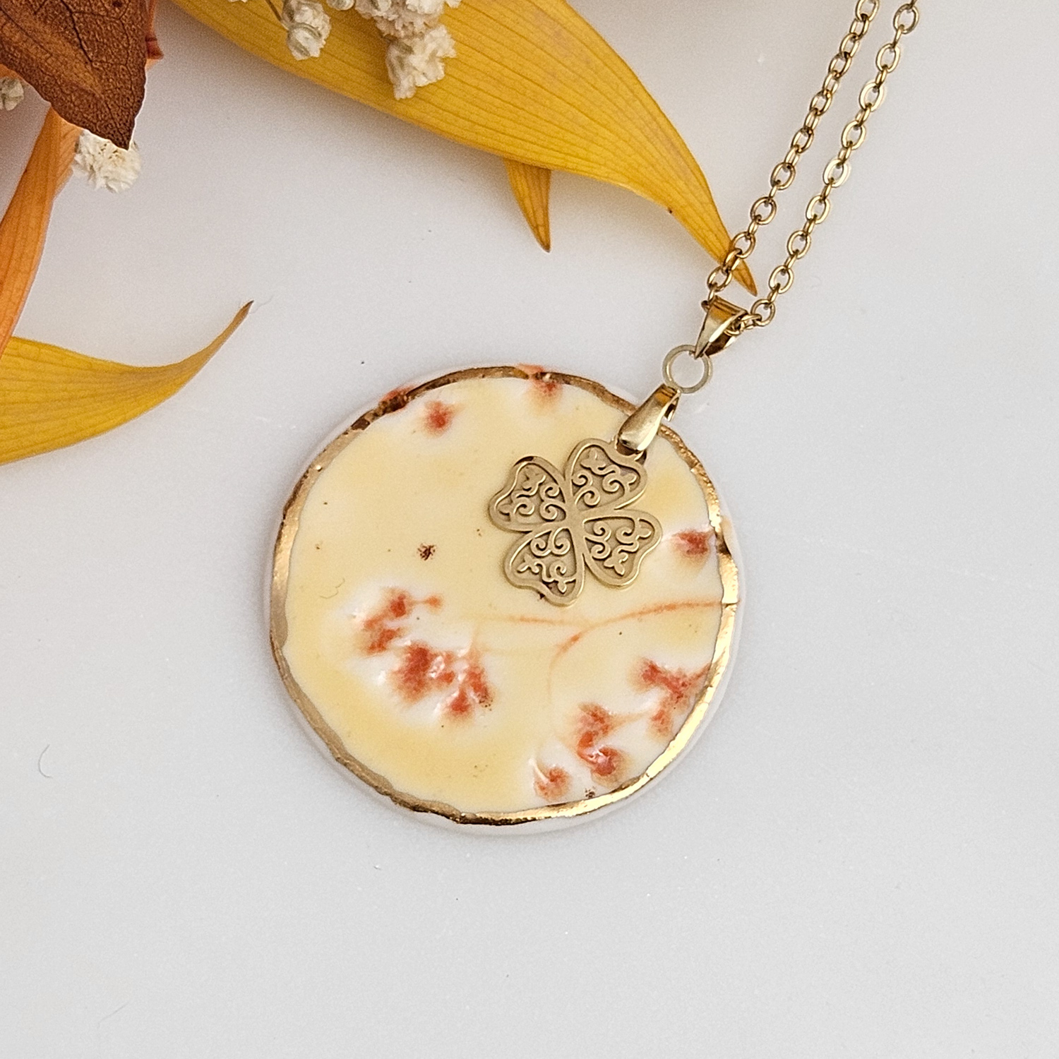 Yellow-red fine ceramic porcelain designer necklace - embossed plant with 22k gold plating and clover pendant