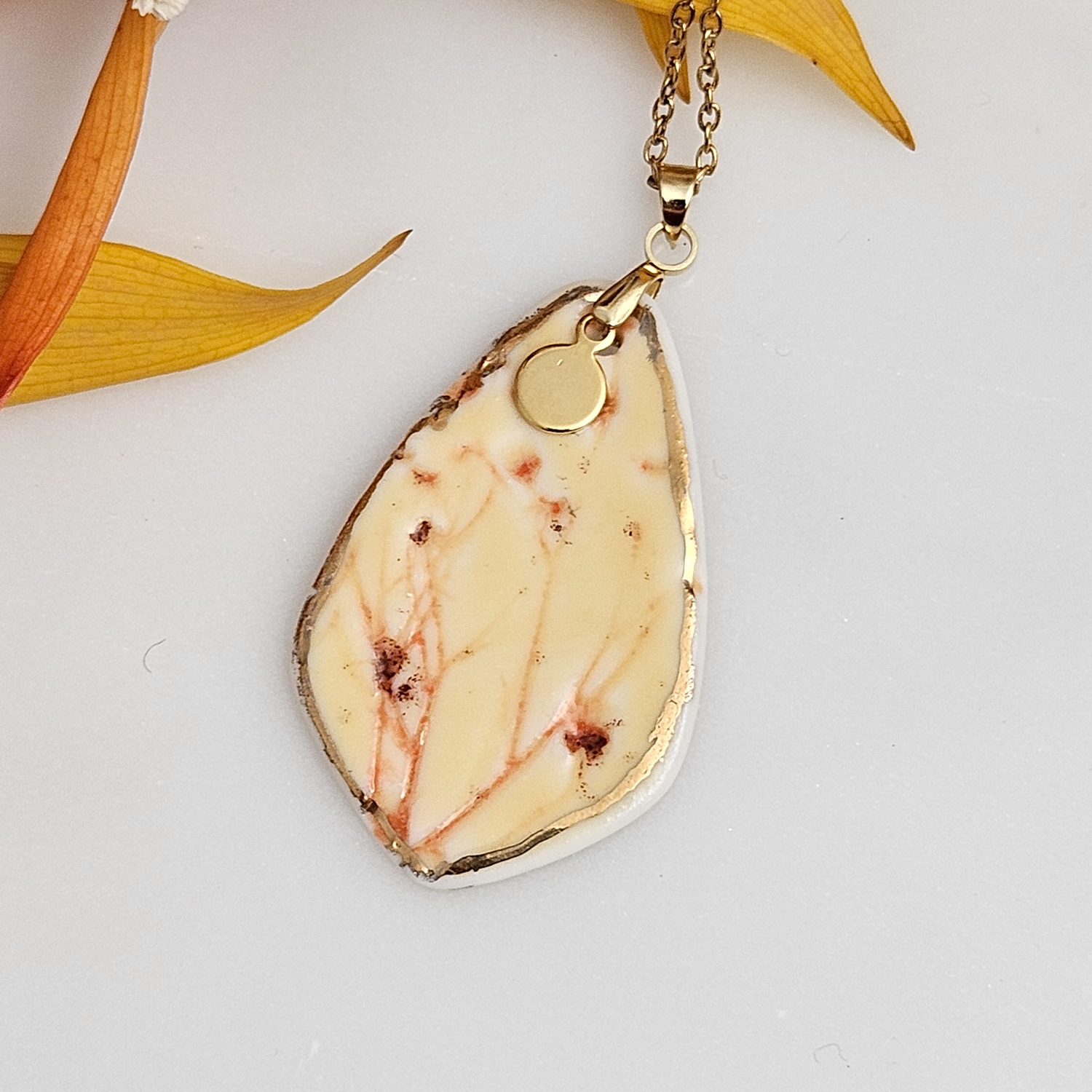 Yellow-red fine ceramic porcelain designer necklace - embossed plant with 22k gold plating and round pendant