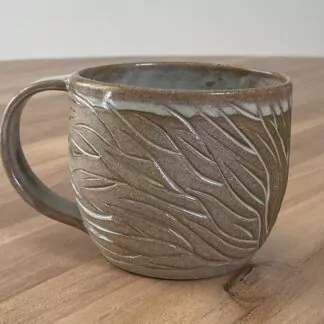 Mug with minty-green glaze and organic carvings (2)