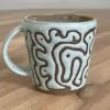 Green mug, masked swirly pattern