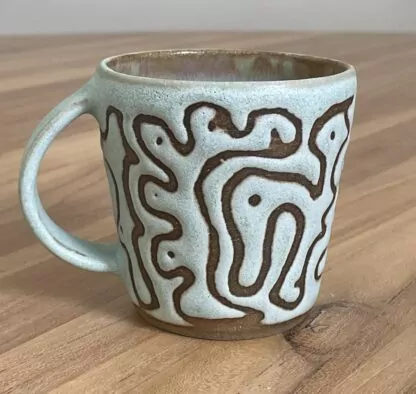 Green mug, masked swirly pattern