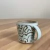 Green mug, masked swirly pattern - Image 3