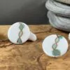 Round earrings with gold and green helix