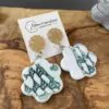 Green flower-shaped napkin earrings with gold-plated rosette