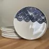 Porcelain dinner plate decorated with crocheted blue embossing