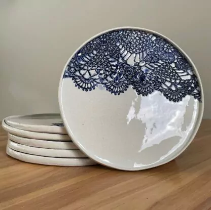 Porcelain dinner plate decorated with crocheted blue embossing
